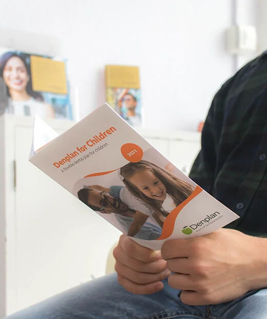 Patient reading a Denplan for Children leaflet in the waiting room