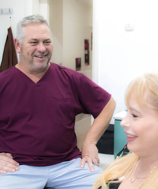 Dentist talking with a patient in Swindon